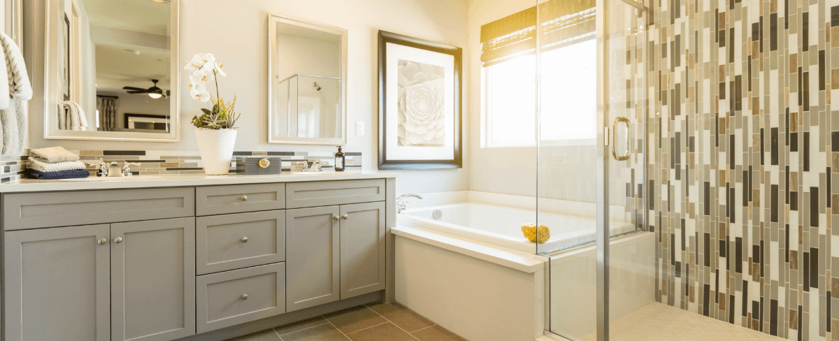 Bathroom Vanity Upgrade with Tile Accent Wall Updated bathroom with a modern vanity, tiled accent wall, and a frameless glass shower enclosure.