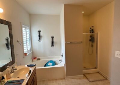 A spacious bathroom remodel with a refreshed double-sink vanity, upgraded walk-in shower, and modern fixtures, creating a clean, functional, and inviting space.