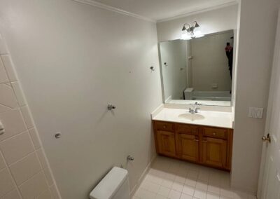 A bathroom ready for a complete remodel, featuring a planned vanity replacement, modern flooring tiles, and updated fixtures, transforming the space into a fresh, contemporary design with improved functionality and aesthetic appeal.