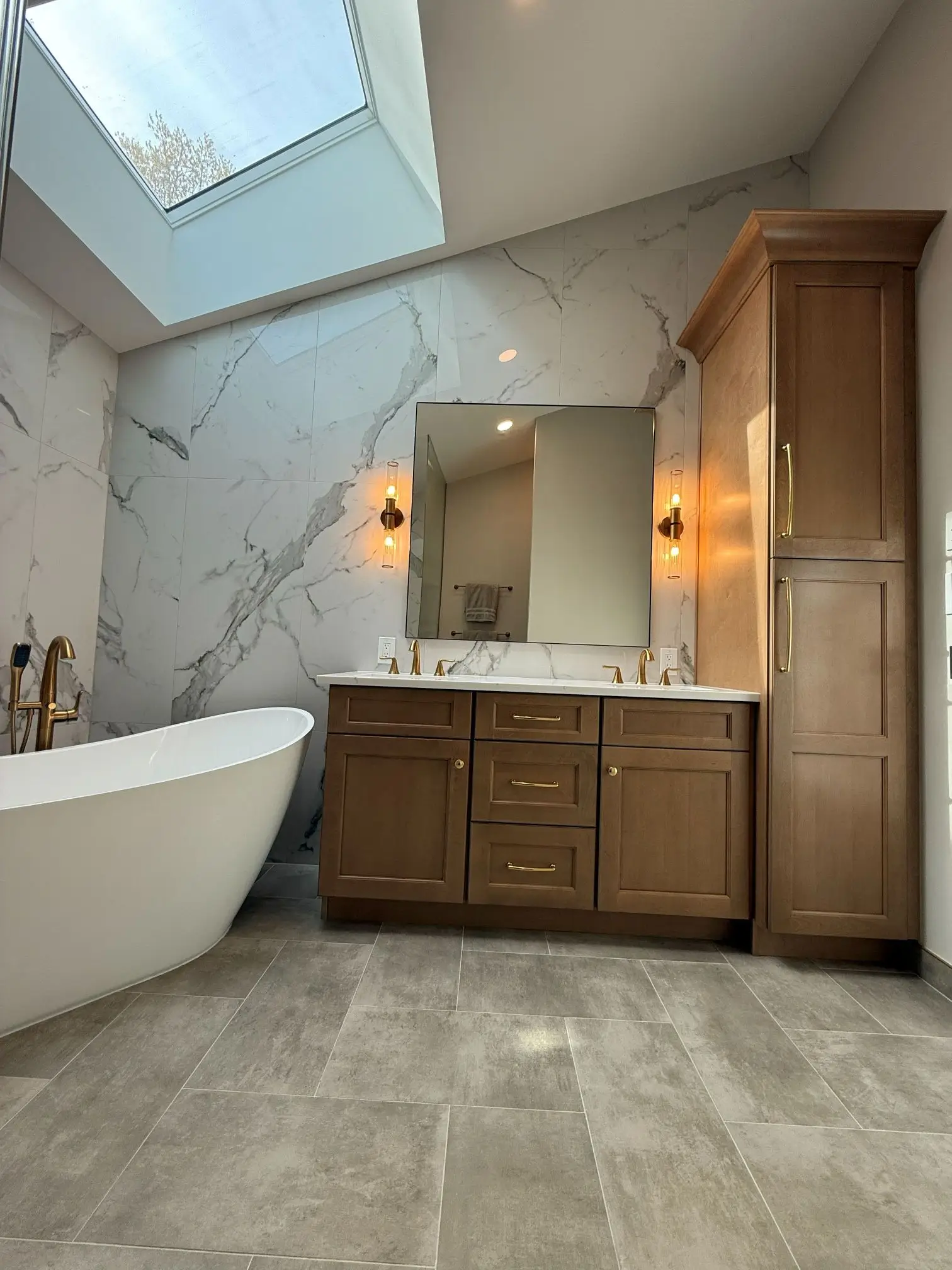Luxury bathroom remodel with skylight and freestanding bathtub
