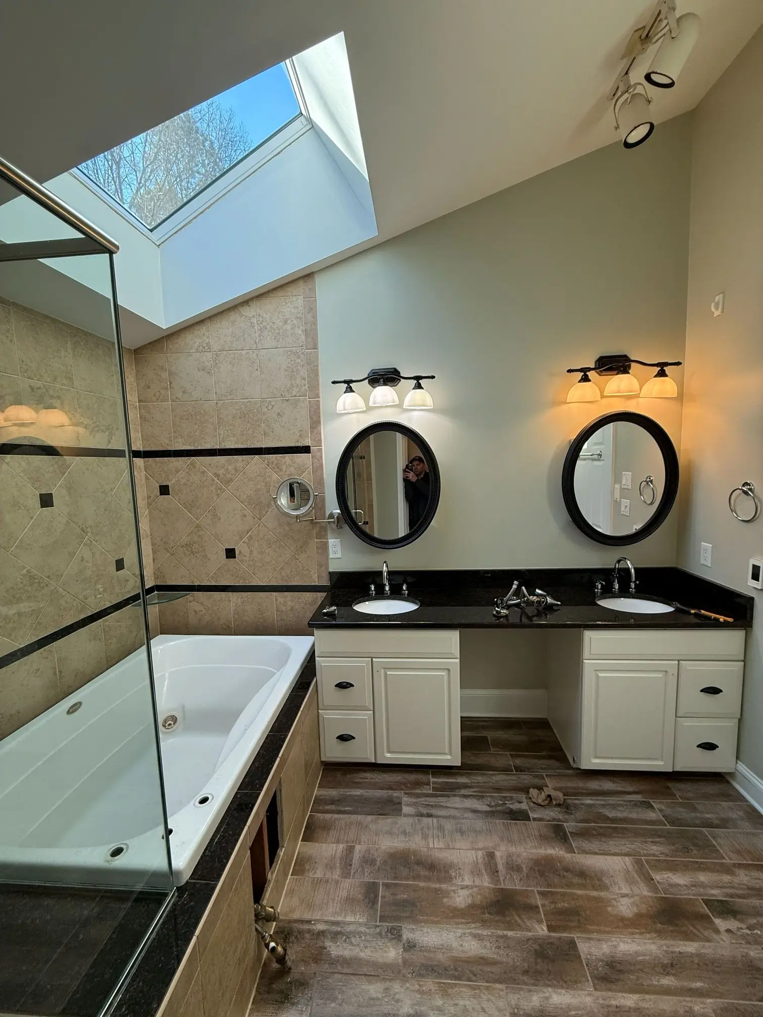 Traditional bathroom before remodeling with old shower and vanity design