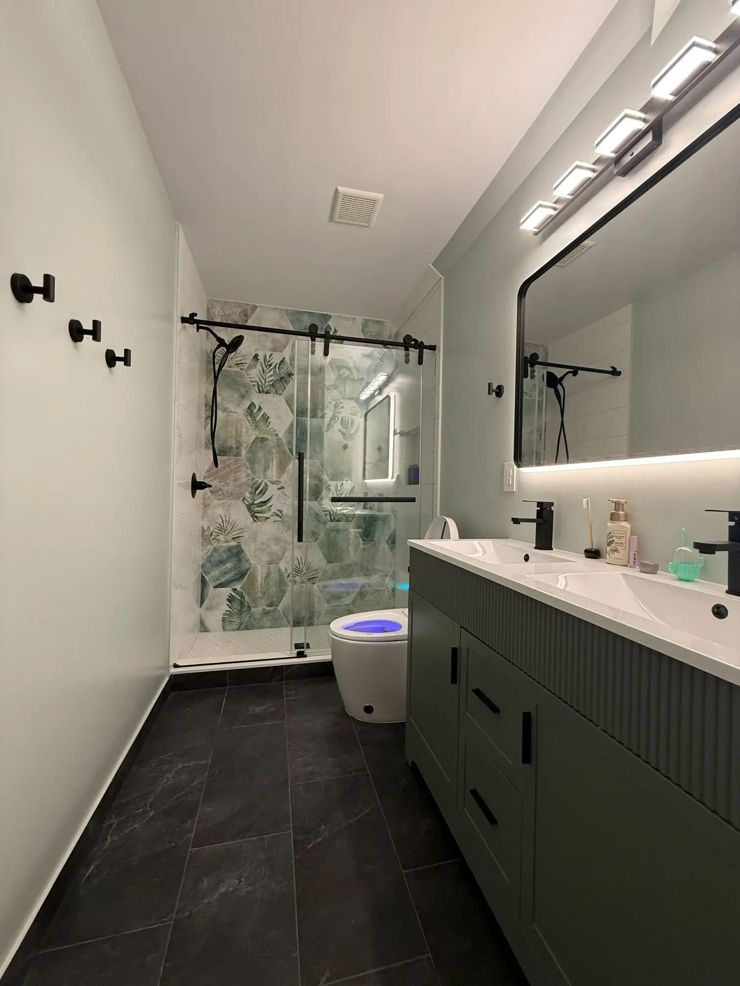 Modern bathroom renovation with double vanity and updated shower