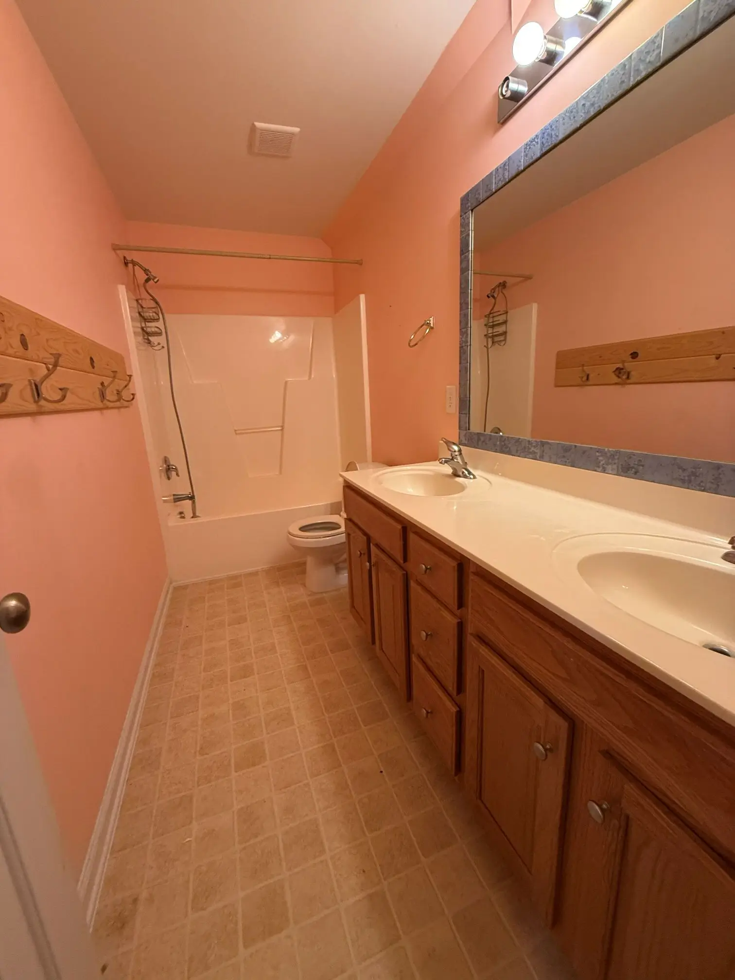 Outdated bathroom before remodeling with old vanity and mirror setup