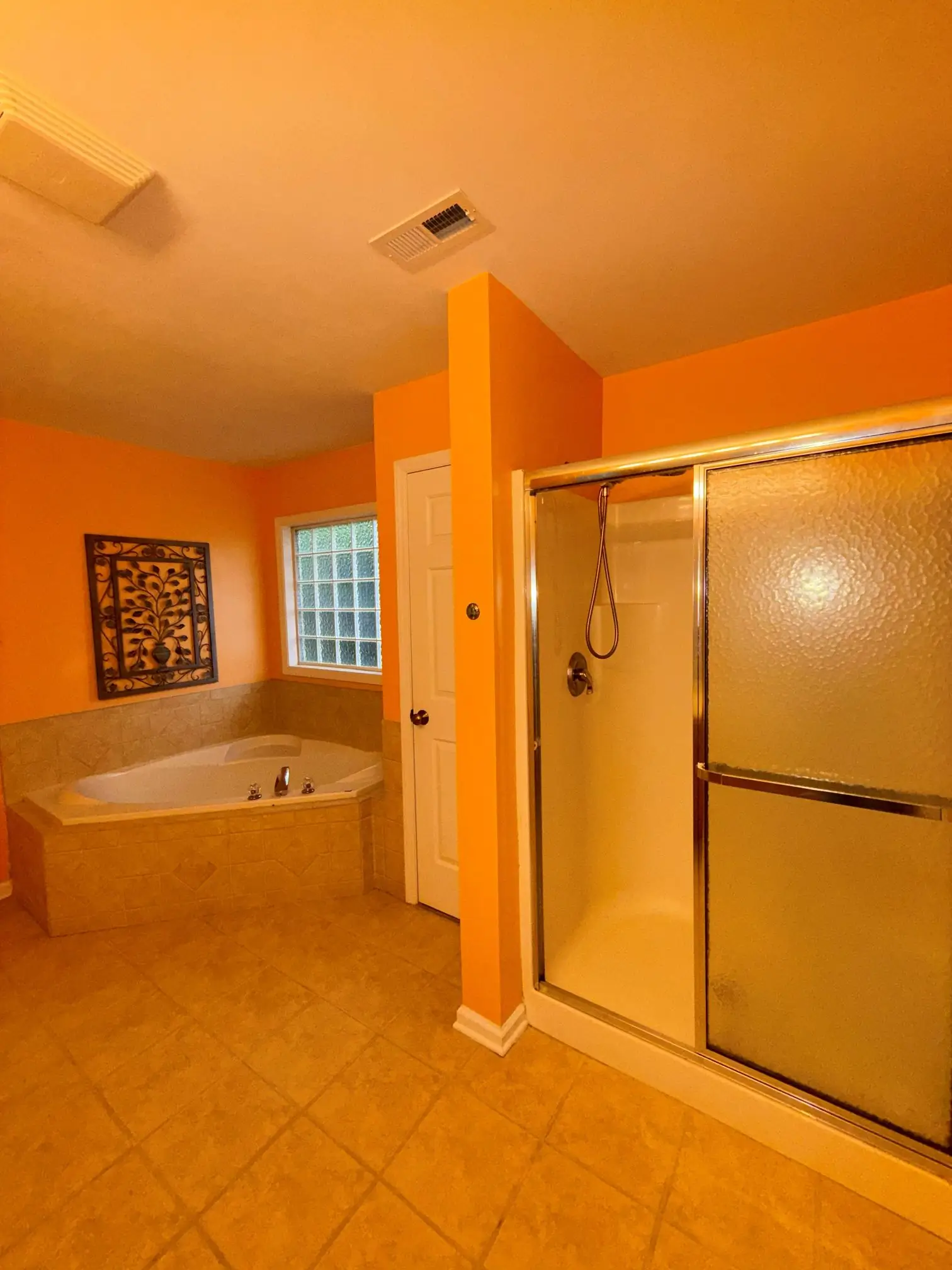 Old bathroom interior before shower renovation with outdated orange walls