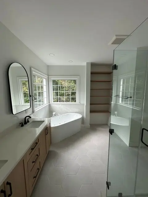 Modern remodeled bathroom with freestanding tub and glass shower