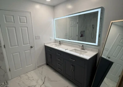 Luxury marble bathroom remodel with custom vanity and LED mirror