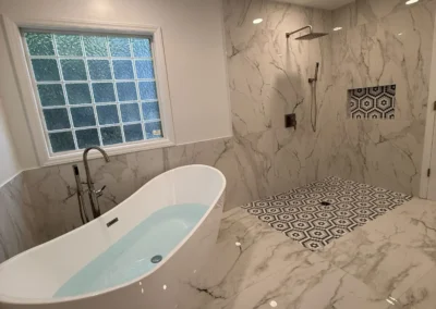 Luxury master bathroom renovation with freestanding tub and marble shower