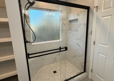 Walk in shower renovation with black frame glass enclosure