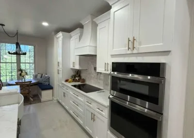 White kitchen remodel with custom cabinetry and built in oven