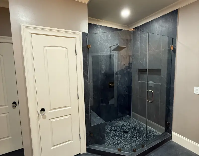 Frameless Walk-In Shower with Dark Stone Tile